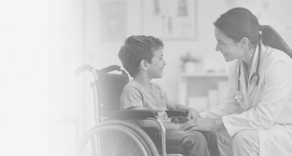 Boy in wheelchair interacting with medical provider
